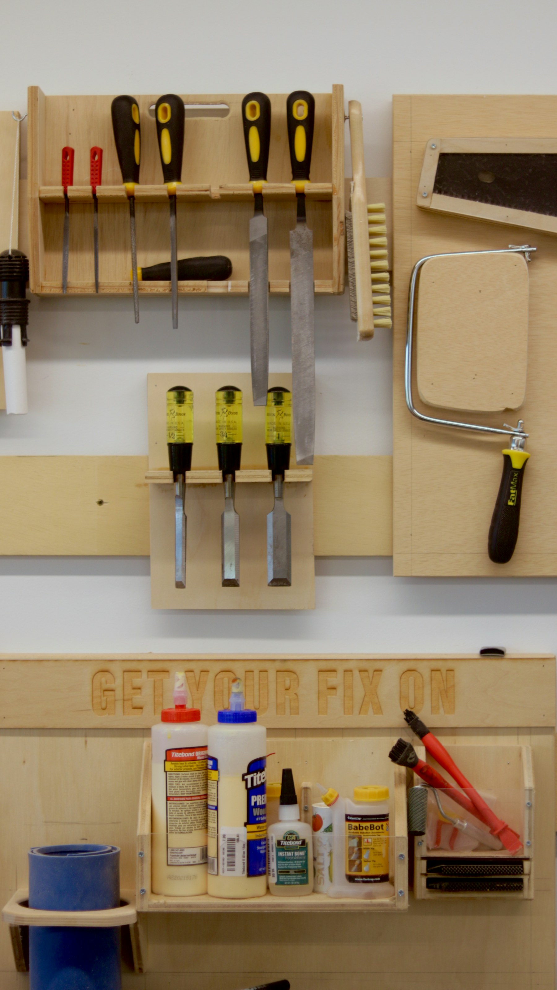 Hand tools arranged on a workshop wall and bench